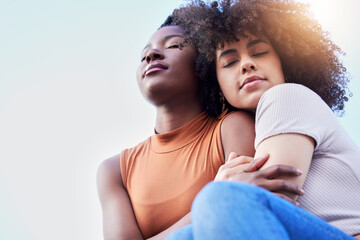 Fototapeta premium Fade into you. Shot of two young women spending time together outdoors.