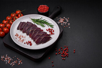 Delicious dried smoked beef or horse meat jerky with spices and salt