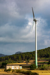 Fototapeta na wymiar Wind turbine installed near a farm to feed itself.
