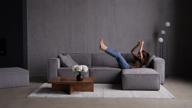 Young woman jump on the couch and relaxing