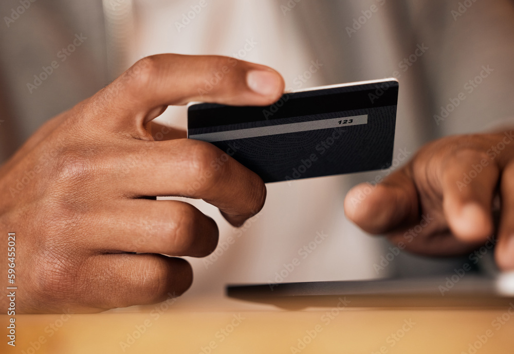 Poster .. man holding credit card and using tablet. closeup of mans hands holding bank card while doing onl