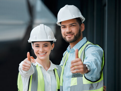 Your building plans have been approved. Cropped portrait of two young construction workers giving thumbs up while standing on a building site.