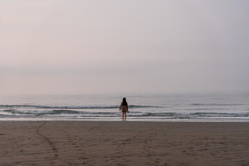 surfer walking on the beach