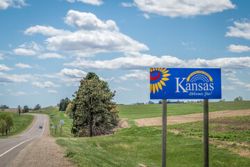 Kansas welcomes you - welcome roadside sign with a popular Latin phrase ad astra per aspera...