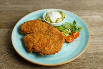 Schnitzel, Fried Chicken with Cucumber salad and vegetables
