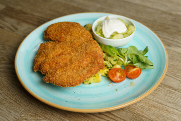 Schnitzel, Fried Chicken with Cucumber salad and vegetables