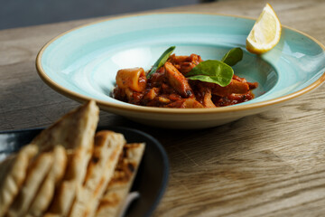 Calamari with Spicy Tomato Sauce, Lemon and Greek Pita Bread