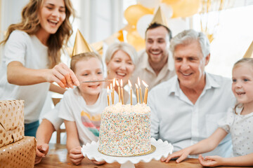 The more candles, the bigger the wish. Shot of a happy family celebrating a birthday at home.