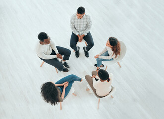 Sometimes, you need other people to help you process. High angle shot of an unrecognisable group of people sitting together and talking during therapy. - Powered by Adobe