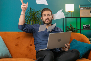 Stressed lebanese man at home room looking at unpaid bank debt bills, doing paperwork, planning...