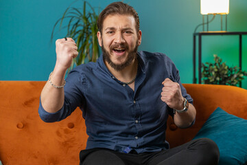 Happy lebanese man shouting, celebrating success, winning, goal achievement good news, lottery...