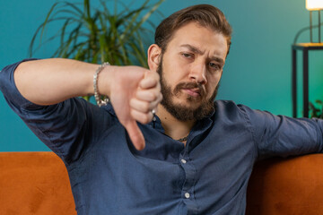 Dislike. Upset lebanese man showing thumbs down sign gesture, expressing discontent, disapproval...