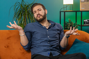 I dont know what to say. Confused lebanese handsome man feeling embarrassed about ambiguous...