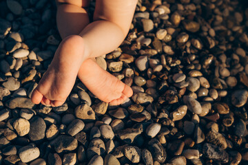 Little child's bare feet  on the beach