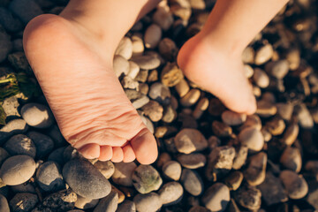 Little child's bare feet  on the beach