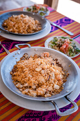 rice with shrimp on a metal pan and accompaniment from the Colombian tropics