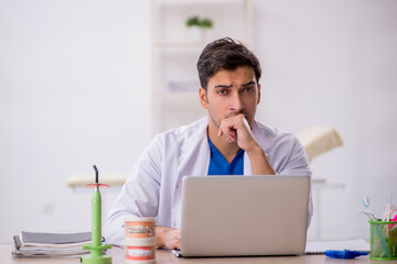 Young male dentist working in the clinic