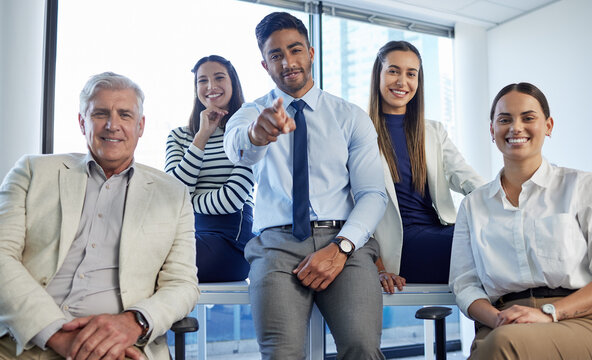 We want you on our team. Shot of a group of businesspeople posing together in an office.
