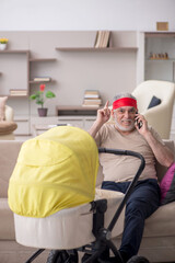 Old man looking after newborn at home