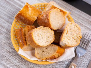 Closeup of fresh spanish bread served in a basket on a table in a restaurant