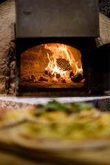 Clay oven with its fire inside, ready to put the pizzas
