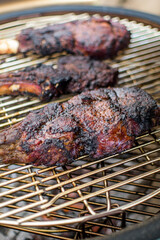 Three portions of pork rib cooked on the grill, ready to eat
