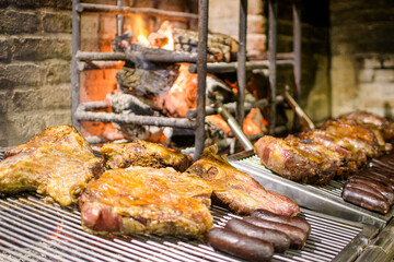 Argentinian grill with cane on the spit and embers cooking in the background fire