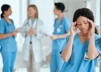 Headaches can get to anyone. Shot of a medical practitioner looking stressed in the middle of a meeting in hospital.