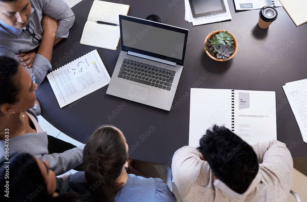 Poster giving it their best shot. shot of an office table with staff using a digital tablet and laptop.