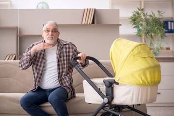 Old man looking after newborn at home