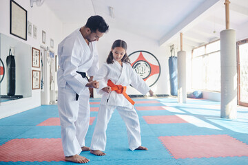 Fototapeta Theres no cant in our karate class. Shot of a young man and cute little girl practicing karate in a studio. obraz