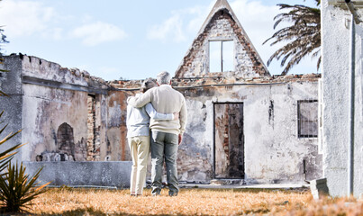 Obraz na płótnie Canvas Insurance is the best investment. Shot of a senior couple comforting each other after losing their home to a fire.