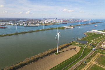 birds-eye view of some modern windmills for electricity generation and an oil refinery, Botlek,...
