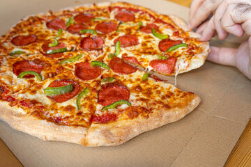 Pepperoni Pizza in Cardboard Delivery Box Closeup, Salami Pizza with Green Paprika, Chili Pepper