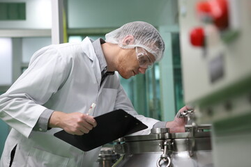 scientist analyzing a biological and ecological hemp plant used for herbal pharmaceutical CBD oil and THC oil in a laboratory.