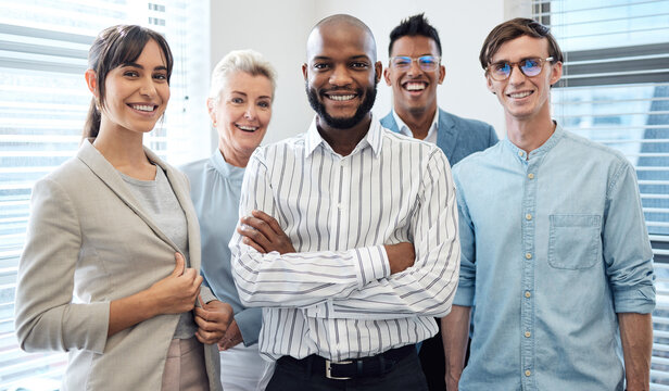 We Achieve The Impossible Together. Portrait Of A Group Of Confident Businesspeople Standing Together In An Office.