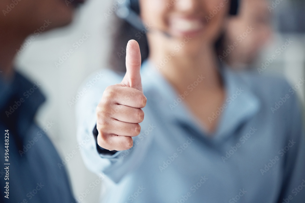 Poster Wrapping up a few calls with success. Closeup shot of an unrecognisable call centre agent showing thumbs up in an office.