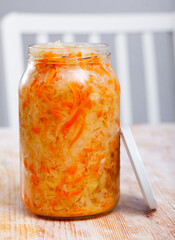 Glass jar with traditional Russian sauerkraut on table, nobody