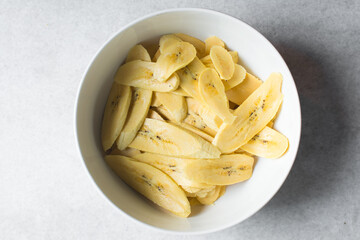 Top view of slices of ripe plantains , slices of yellow plantains for frying, process for making fried plantain