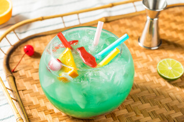 Fototapeta na wymiar Boozy Cold Blue Tiki Fishbowl Cocktail
