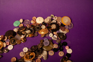 clothes buttons, sewing buttons on purple background