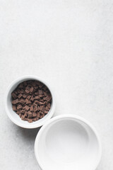 Pieces of chopped dark chocolate for baking in a ramekin, Dark chocolate chunks