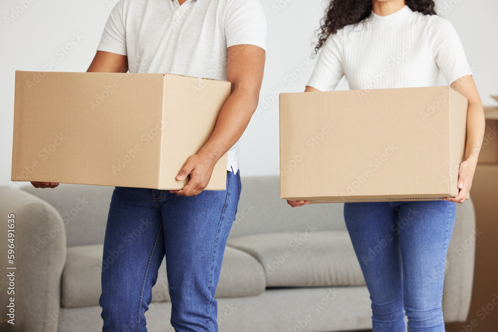 Poster Ill help lighten the load for you. Shot of a young couple holding boxes in their new house.