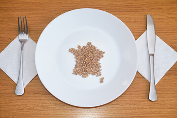 Wheat on a plate laid out in the shape of a map of France. Food concept