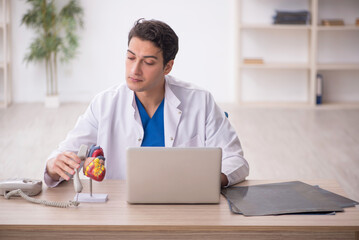 Young male doctor cardiologist working in the clinic