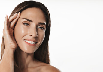 Smiling 40s years middle-aged woman with healthy, clear glowing skin, no wrinkles, using anti-aging beauty products, hyaluronic acid and nourishing creams for natural glow and lifting effect