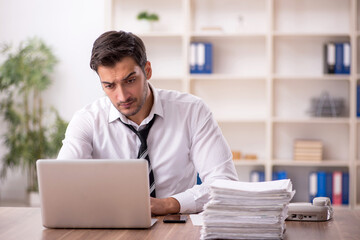 Young male employee working in the office
