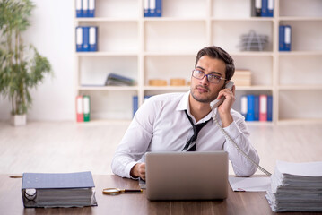 Young male employee working in the office