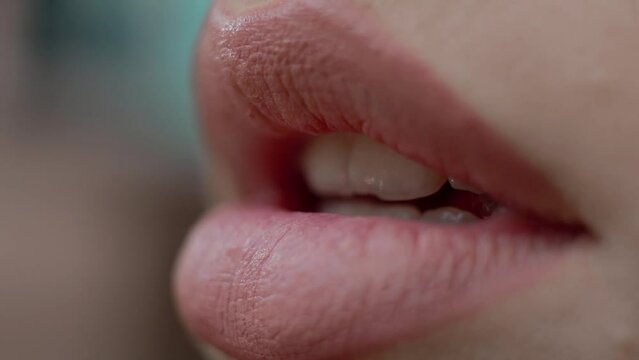 the girl purses her lips after painting with red lipstick, preparing for a date.close-up shot.