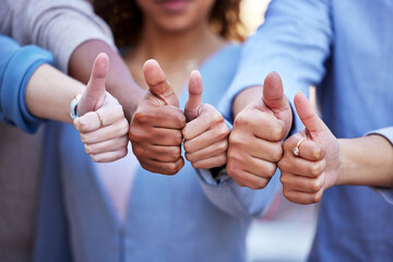 We cannot do it alone. Shot of a group of business people giving the thumbs up.